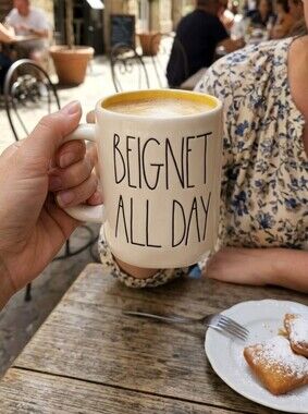 Ceramic mug titled 'Beignet All Day' by Rae Dunn
